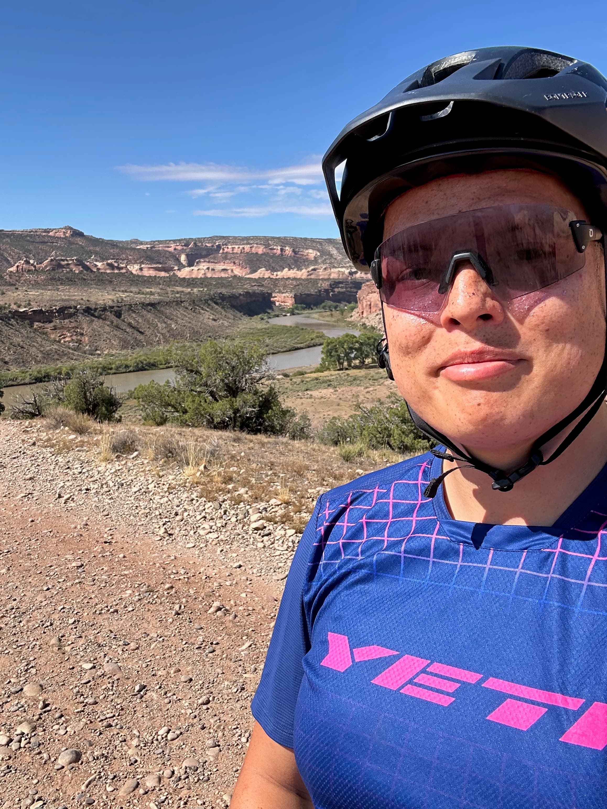 Michelle Hadfield in a bike helmet in front of a river in the desert